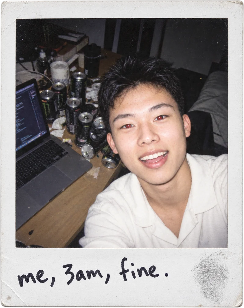 Polaroid of Yusei at a desk buried in empty cans, captioned: me, 3am, fine.